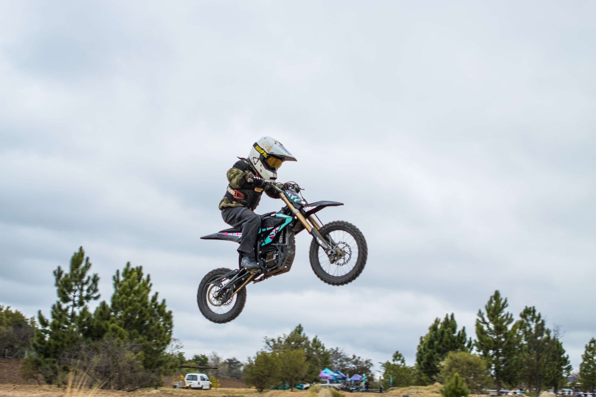 Rider jumping high at a Surron SA track day